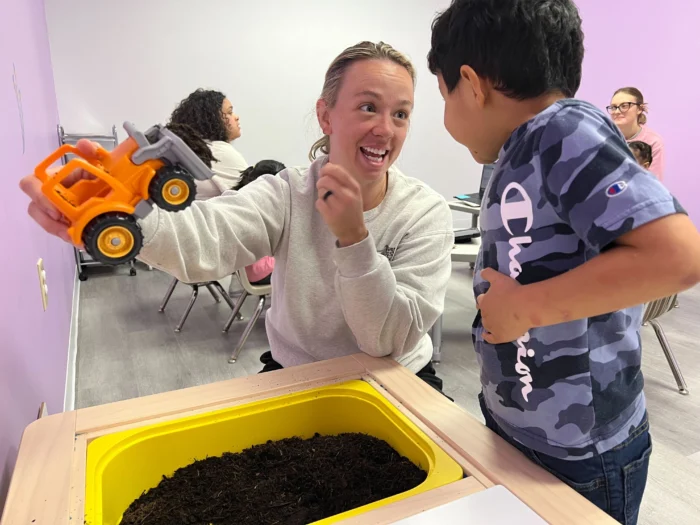 Abacus Therapies - ABA Therapy for Kids Charlotte NC - RBT showing an activity to an excited child
